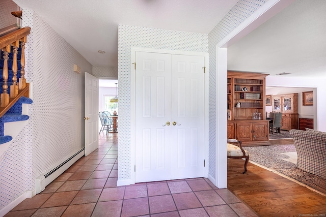 9 Meadowbrook Rd, New Fairfield, CT 06812 - corridor featuring a baseboard heating unit, wallpapered walls, tile patterned floors, a desk, and baseboards