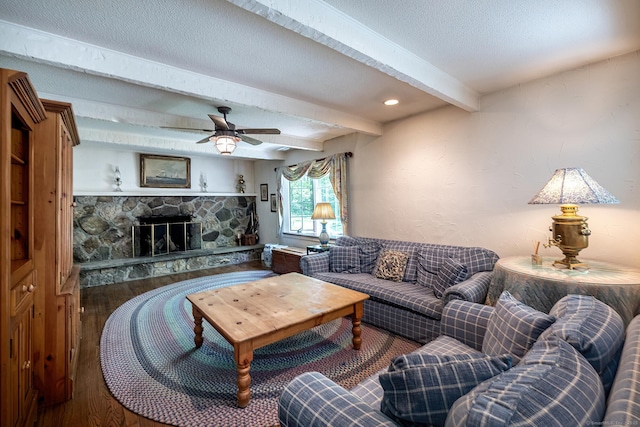 9 Meadowbrook Rd, New Fairfield, CT 06812 - living area featuring wood finished floors, beam ceiling, a ceiling fan, a stone fireplace, and a textured ceiling