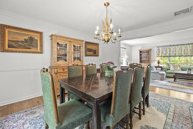 9 Meadowbrook Rd, New Fairfield, CT 06812 - dining space with a chandelier, wood finished floors, ornamental molding, and baseboards