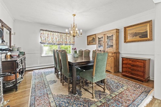 9 Meadowbrook Rd, New Fairfield, CT 06812 - dining room featuring a baseboard radiator, crown molding, a chandelier, light wood-style flooring, and a textured ceiling