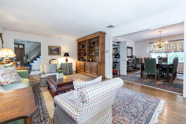 9 Meadowbrook Rd, New Fairfield, CT 06812 - living area featuring a chandelier, light wood finished floors, and stairs