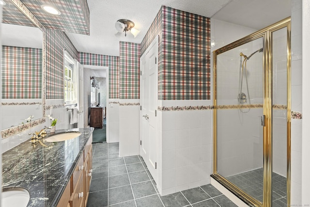 9 Meadowbrook Rd, New Fairfield, CT 06812 - full bath featuring double vanity, tile patterned floors, a stall shower, wallpapered walls, and a textured ceiling