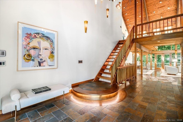 93 Graenest Ridge Rd, Wilton, CT 06897 - staircase featuring a high ceiling, stone tile floors, and baseboards