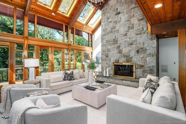 93 Graenest Ridge Rd, Wilton, CT 06897 - carpeted living room featuring a skylight, high vaulted ceiling, wooden ceiling with exposed beams, and a stone fireplace
