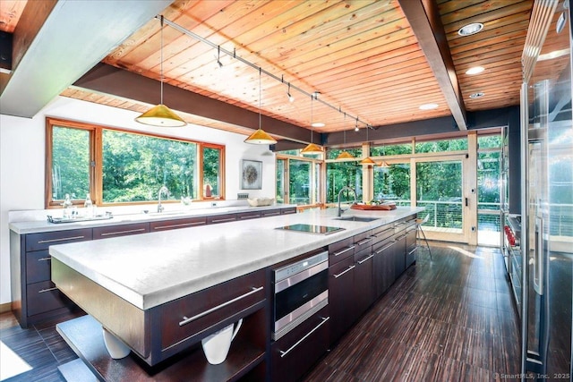 93 Graenest Ridge Rd, Wilton, CT 06897 - kitchen featuring wood ceiling, a sink, track lighting, black electric stovetop, and stainless steel microwave
