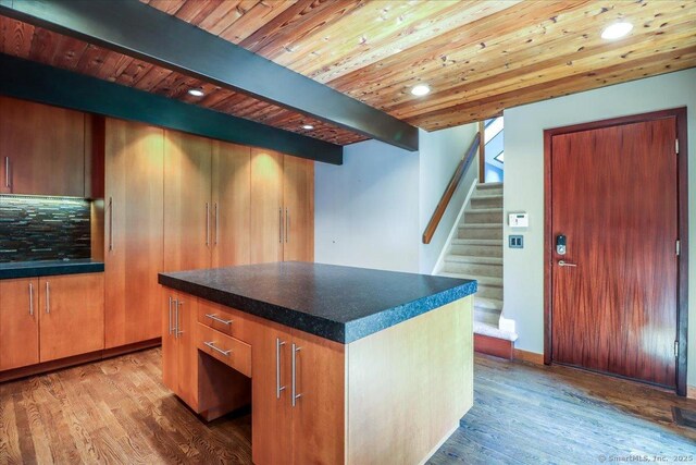 93 Graenest Ridge Rd, Wilton, CT 06897 - bar area featuring stairs, wood finished floors, wooden ceiling with exposed beams, recessed lighting, and backsplash