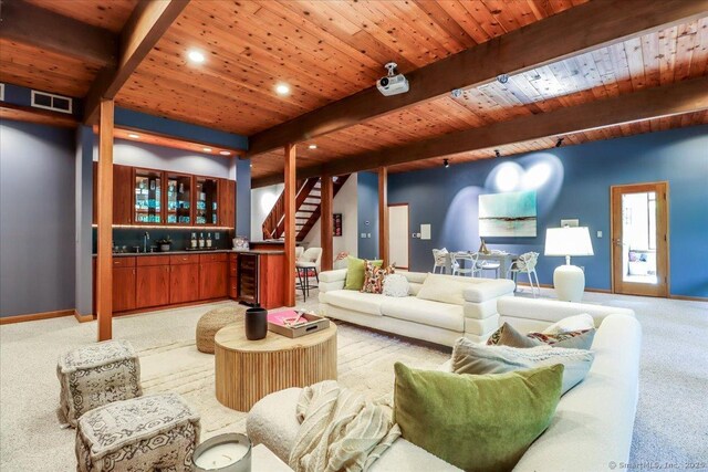 93 Graenest Ridge Rd, Wilton, CT 06897 - living room with light carpet, wine cooler, bar, wooden ceiling with exposed beams, and stairway