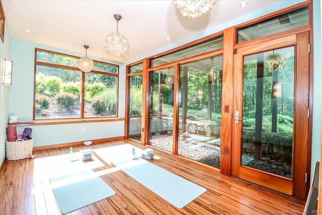 93 Graenest Ridge Rd, Wilton, CT 06897 - workout room with a chandelier, baseboards, and wood finished floors