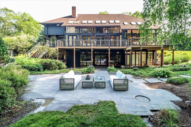 93 Graenest Ridge Rd, Wilton, CT 06897 - back of property featuring a patio, stairs, outdoor lounge area, and a chimney
