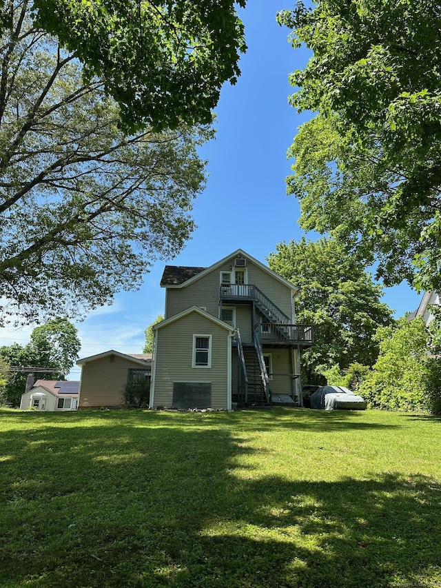 59 Rowan St, Danbury, CT 06810 - back of property with stairway, a yard, and a wooden deck