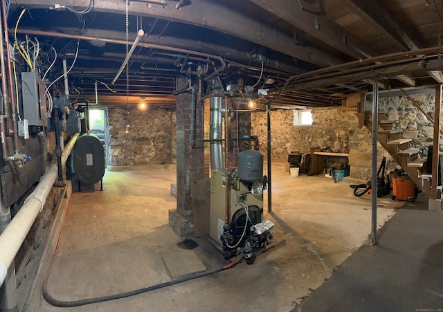 59 Rowan St, Danbury, CT 06810 - below grade area with oil tank, electric panel, a heating unit, and stairs