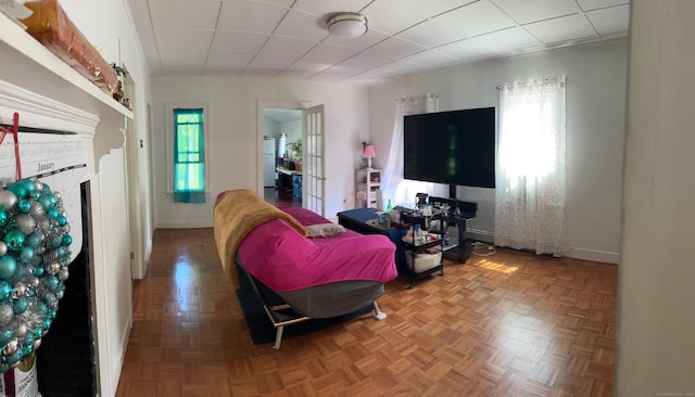 59 Rowan St, Danbury, CT 06810 - living room featuring baseboards, a paneled ceiling, and a fireplace