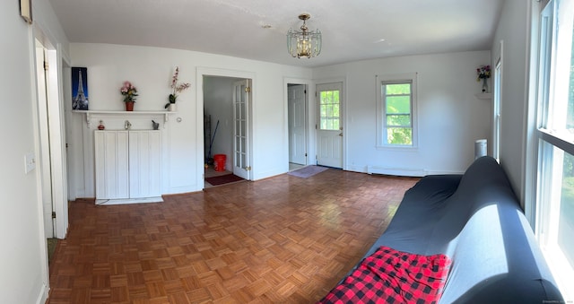 59 Rowan St, Danbury, CT 06810 - living room with a baseboard heating unit, baseboards, and a chandelier