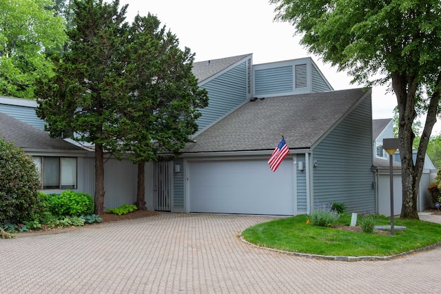 504 Harvest Commons Unit 504, Westport, CT 06880 - mid-century modern home featuring an attached garage, roof with shingles, and driveway