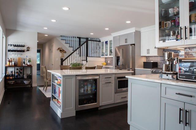 504 Harvest Commons Unit 504, Westport, CT 06880 - kitchen with wine cooler, gray cabinets, dark wood-style flooring, decorative backsplash, and recessed lighting