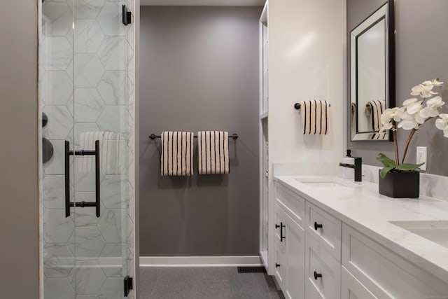 504 Harvest Commons Unit 504, Westport, CT 06880 - full bathroom featuring double vanity, a marble finish shower, and baseboards