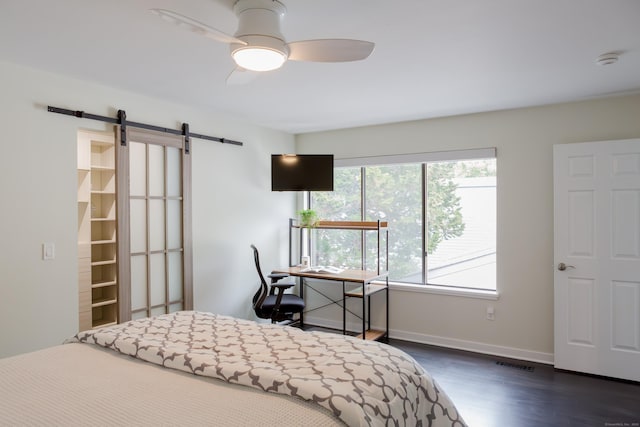 504 Harvest Commons Unit 504, Westport, CT 06880 - bedroom with dark wood-style floors, a barn door, baseboards, and ceiling fan
