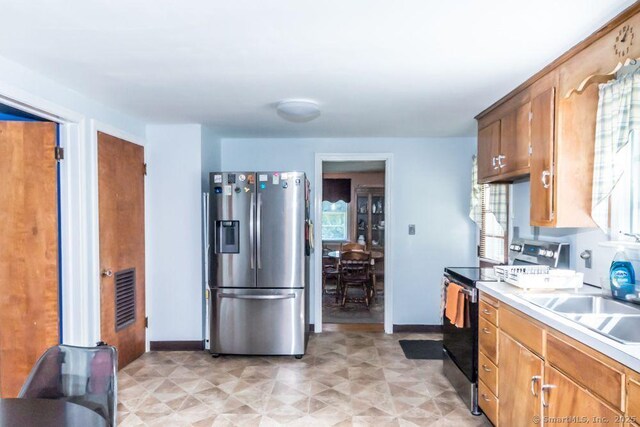 45 S Eagle St, Plymouth, CT 06786 - kitchen featuring appliances with stainless steel finishes, baseboards, light countertops, and a sink