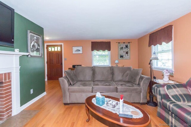 45 S Eagle St, Plymouth, CT 06786 - living area featuring light wood finished floors, a fireplace, and baseboards