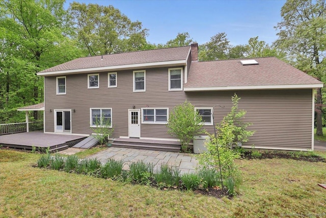 1155 Arbutus St, Middletown, CT 06457 - rear view of house with a wooden deck, a lawn, central air condition unit, and a shingled roof
