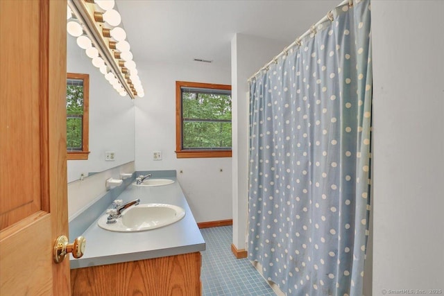 1155 Arbutus St, Middletown, CT 06457 - bathroom featuring tile patterned floors, a shower with shower curtain, and double vanity