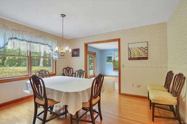 1155 Arbutus St, Middletown, CT 06457 - dining space with wallpapered walls, a chandelier, light wood finished floors, and plenty of natural light