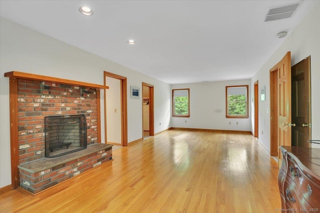 1155 Arbutus St, Middletown, CT 06457 - unfurnished living room with light wood-type flooring, a fireplace, baseboards, and recessed lighting
