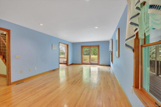 1155 Arbutus St, Middletown, CT 06457 - empty room featuring healthy amount of natural light, light wood-style floors, baseboards, stairway, and recessed lighting