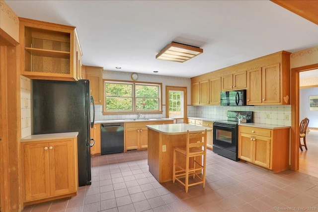 1155 Arbutus St, Middletown, CT 06457 - kitchen with black appliances, light tile patterned floors, light countertops, backsplash, and a center island