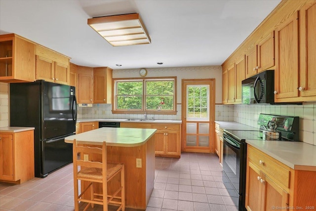 1155 Arbutus St, Middletown, CT 06457 - kitchen with black appliances, light tile patterned flooring, and decorative backsplash