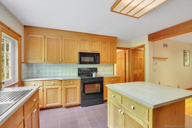 1155 Arbutus St, Middletown, CT 06457 - kitchen featuring black appliances, decorative backsplash, light countertops, light tile patterned floors, and a kitchen island