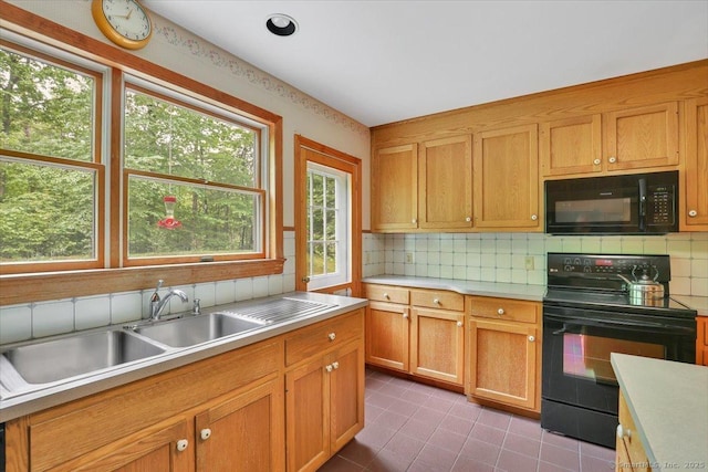 1155 Arbutus St, Middletown, CT 06457 - kitchen featuring black appliances, light countertops, backsplash, a sink, and tile patterned floors