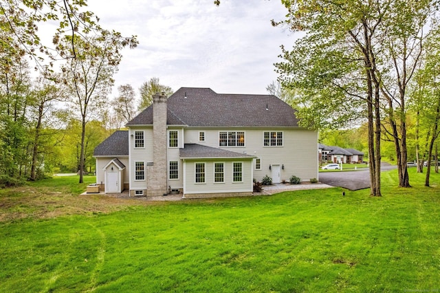 64 Warren Gln, Burlington, CT 06013 - rear view of property featuring a chimney, a lawn, and a shingled roof