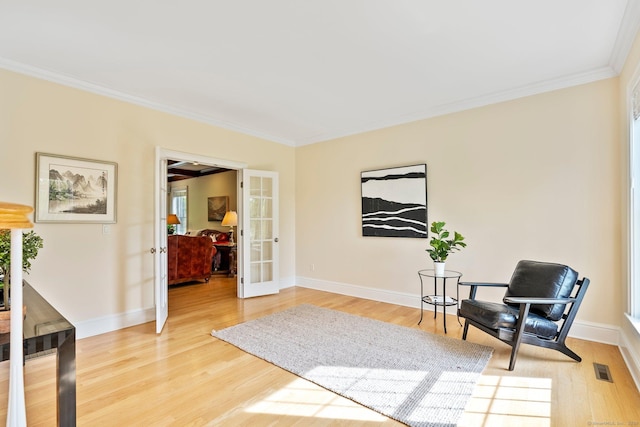 64 Warren Gln, Burlington, CT 06013 - living area with french doors, crown molding, light wood-style floors, and baseboards