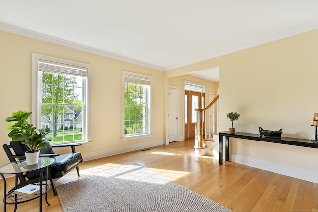 64 Warren Gln, Burlington, CT 06013 - living area with wood finished floors, ornamental molding, baseboards, and stairs
