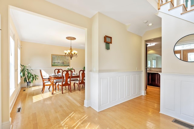 64 Warren Gln, Burlington, CT 06013 - hall with light wood finished floors, a chandelier, and a wainscoted wall