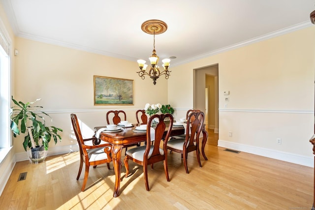 64 Warren Gln, Burlington, CT 06013 - dining area featuring a chandelier, light wood-style floors, crown molding, and baseboards