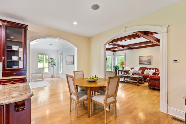 64 Warren Gln, Burlington, CT 06013 - dining space featuring arched walkways, light wood-type flooring, healthy amount of natural light, beamed ceiling, and coffered ceiling
