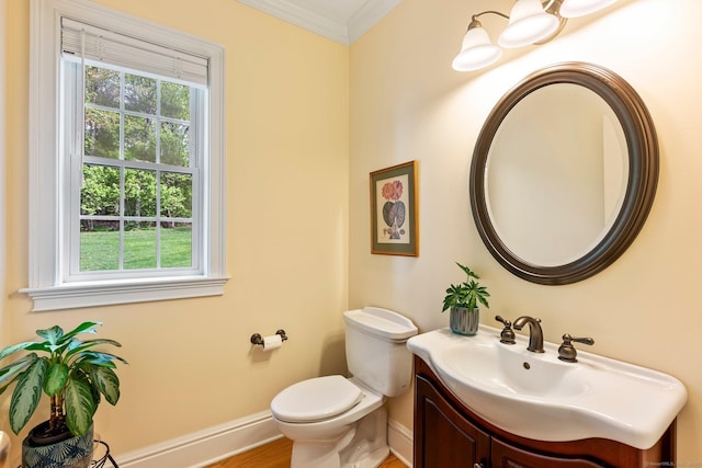 64 Warren Gln, Burlington, CT 06013 - half bath featuring crown molding, baseboards, toilet, vanity, and wood finished floors