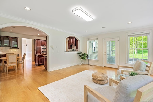 64 Warren Gln, Burlington, CT 06013 - living room featuring crown molding, light wood-style floors, arched walkways, baseboards, and recessed lighting