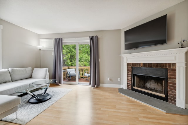 745 Merrow Rd Apt 113, Coventry, CT 06238 - living area with wood finished floors, a fireplace, and baseboards