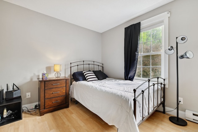745 Merrow Rd Apt 113, Coventry, CT 06238 - bedroom with wood finished floors, a baseboard heating unit, and baseboards