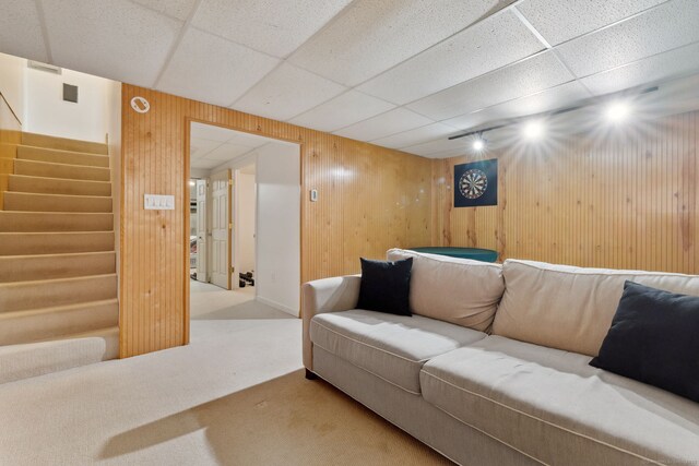 745 Merrow Rd Apt 113, Coventry, CT 06238 - living room with carpet, wooden walls, stairs, and a paneled ceiling