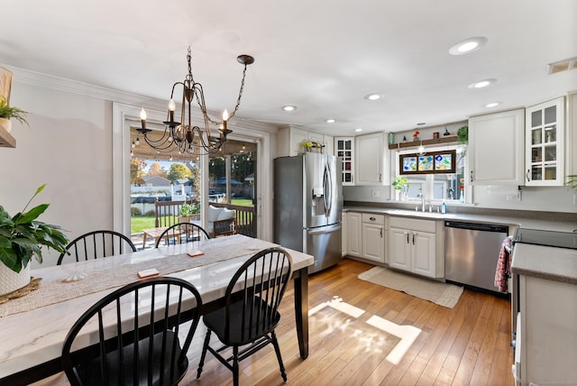 17 Saint Thomas St, Enfield, CT 06082 - kitchen featuring appliances with stainless steel finishes, a chandelier, a sink, white cabinetry, and glass insert cabinets