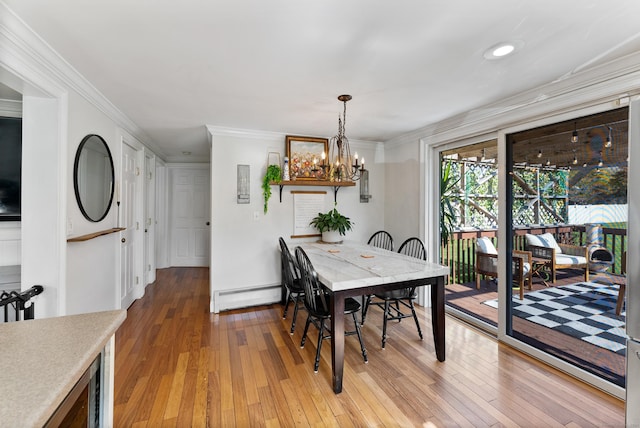 17 Saint Thomas St, Enfield, CT 06082 - dining room featuring baseboard heating, light wood finished floors, a chandelier, crown molding, and recessed lighting