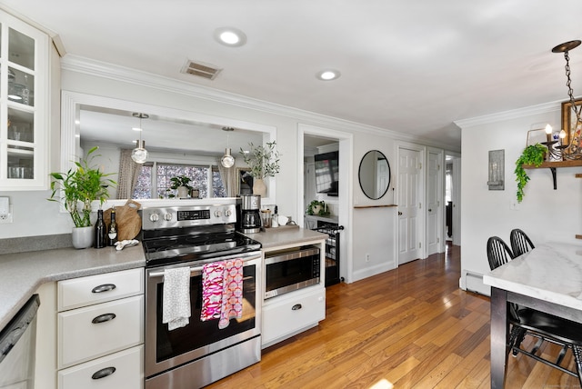 17 Saint Thomas St, Enfield, CT 06082 - kitchen featuring stainless steel appliances, white cabinetry, light countertops, ornamental molding, and light wood-type flooring