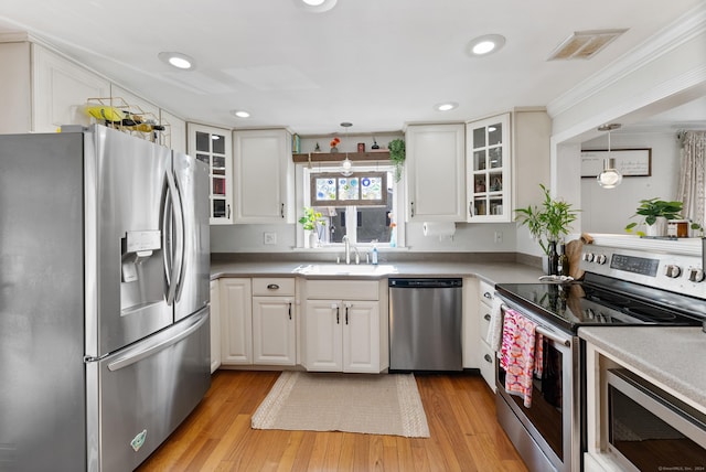 17 Saint Thomas St, Enfield, CT 06082 - kitchen with stainless steel appliances, a sink, light wood finished floors, white cabinetry, and recessed lighting