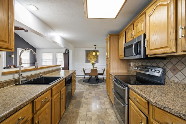 53 Roosevelt Blvd, Enfield, CT 06082 - kitchen with stainless steel appliances, a sink, backsplash, stone finish flooring, and brown cabinets