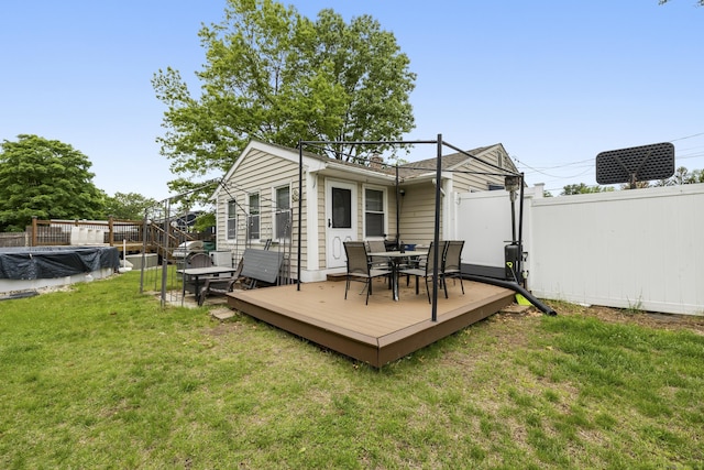 53 Roosevelt Blvd, Enfield, CT 06082 - rear view of house with a wooden deck and outdoor dining area
