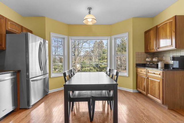 dining room with light wood-style flooring and baseboards